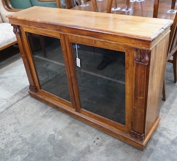 A Victorian and later faded rosewood two door bookcase, width 132cm, depth 33cm, height 90cm